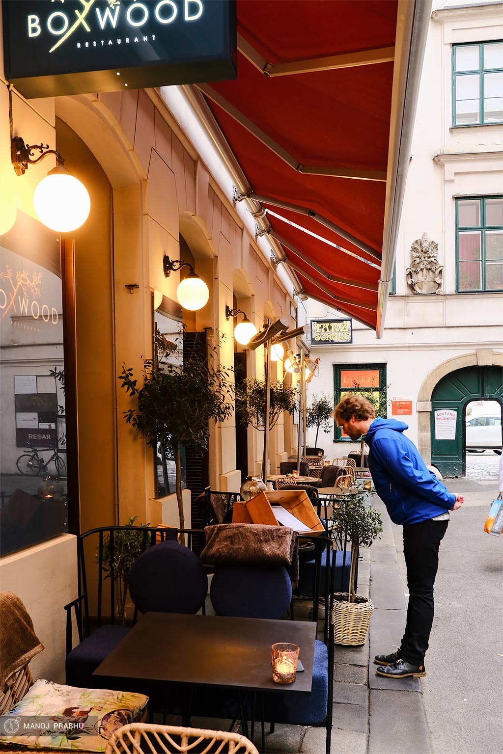 A man studying a menu of a restaurant. (Shot on Fujifilm X-Pro2 using Kodak Ektar 100 film simulation recipe)